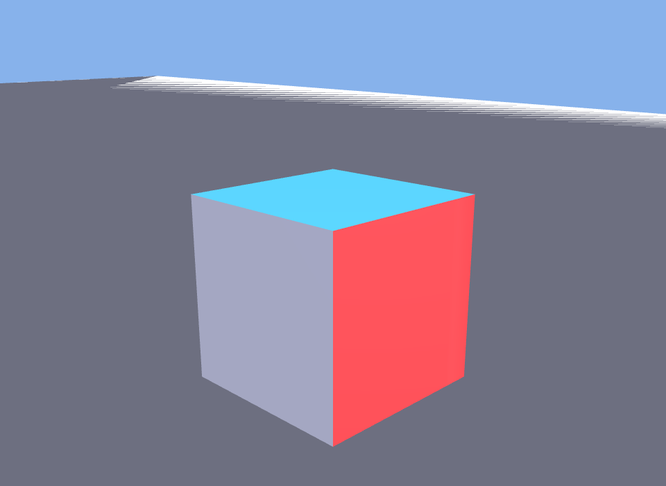 A cube on a gray platform seen from a three-quarter angle against a blue sky. Its front face is bright red, its top face is light blue, and its visible side face is plain light gray, demonstrating three different per-face colors on a single object.